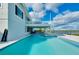 Sparkling backyard pool, outdoor seating, and scenic view of the river from the back of the home at 9061 Kellogg Ln, Venice, FL 34293