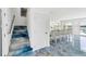 Staircase leading to interior with sleek tile floors and water view beyond at 9061 Kellogg Ln, Venice, FL 34293