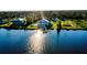 Waterfront home with a private dock, lush surroundings, and serene water views at 9061 Kellogg Ln, Venice, FL 34293