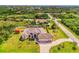 Expansive aerial view of the property showcasing lush landscaping, a large screened pool, and a well-maintained home exterior at 9407 Prospect Ave, Englewood, FL 34224