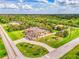 Overview of the property showing surrounding foliage, a circular driveway, and the home's layout, set on a large lot at 9407 Prospect Ave, Englewood, FL 34224