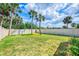 Spacious backyard featuring a well-maintained lawn and white vinyl fence at 9407 Prospect Ave, Englewood, FL 34224