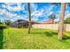Manicured backyard with a screened lanai, lush lawn, and a white fence, offering a private outdoor space for relaxation at 9407 Prospect Ave, Englewood, FL 34224