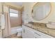 Bathroom with a single sink vanity with granite countertops, a bathtub with shower, and a large mirror at 9407 Prospect Ave, Englewood, FL 34224