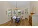 Cozy breakfast nook with four chairs, a round table, and natural light from large windows at 9407 Prospect Ave, Englewood, FL 34224