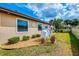Exterior view of home showcasing manicured landscaping, garden beds, and propane tank at 9407 Prospect Ave, Englewood, FL 34224