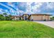 Beautiful home featuring manicured lawn, multi car garage and arched entry way at 9407 Prospect Ave, Englewood, FL 34224