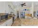 Spacious kitchen featuring white cabinets, stainless steel appliances, granite countertops, and tile flooring at 9407 Prospect Ave, Englewood, FL 34224