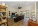 Open living area with tile floor, ceiling fan, and sliding doors to outdoor pool at 9407 Prospect Ave, Englewood, FL 34224