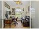 Bright home office with a leather couch, wooden desk, and tiled floors at 9407 Prospect Ave, Englewood, FL 34224