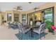 Spacious screened-in lanai with dining and seating areas, perfect for outdoor entertaining at 9407 Prospect Ave, Englewood, FL 34224