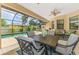 Inviting screened-in patio with comfortable seating, dining table and a view of the sparkling pool at 9407 Prospect Ave, Englewood, FL 34224