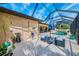 Relaxing screened-in pool area with lounge chairs, table, and lush landscaping at 9407 Prospect Ave, Englewood, FL 34224