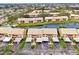 An aerial view of the condo community showcasing waterfront property and pool access at 410 Mission E Trl # H, Venice, FL 34285