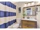 Charming bathroom features a modern vanity, stylish mirror, and updated fixtures at 410 Mission E Trl # H, Venice, FL 34285