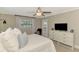 Comfortable bedroom with backyard access featuring soft natural light, a ceiling fan, and tasteful decorations at 410 Mission E Trl # H, Venice, FL 34285