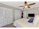 Spacious bedroom featuring a ceiling fan and closet storage at 410 Mission E Trl # H, Venice, FL 34285