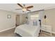 Comfortable bedroom with plenty of storage, featuring soft natural light, a ceiling fan, and tasteful decorations at 410 Mission E Trl # H, Venice, FL 34285
