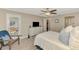 Comfortable bedroom with backyard access featuring soft natural light, a ceiling fan, and tasteful decorations at 410 Mission E Trl # H, Venice, FL 34285