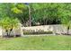 Inviting entrance to Mission Lakes community featuring lush landscaping and signage at 410 Mission E Trl # H, Venice, FL 34285