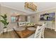 Dining area with modern lighting, a view of the kitchen, and a view of the bar area at 410 Mission E Trl # H, Venice, FL 34285