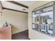 View of a condo entryway with a brick accent wall and decorative display shelf at 410 Mission E Trl # H, Venice, FL 34285
