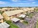 Aerial view of a two-story condo community featuring mature landscaping and covered parking at 410 Mission E Trl # H, Venice, FL 34285