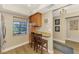 Inviting kitchen nook with granite countertop, ample natural light, and a cozy seating area at 410 Mission E Trl # H, Venice, FL 34285
