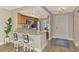 Eat-in kitchen with granite countertops, stainless steel appliances, and natural light at 410 Mission E Trl # H, Venice, FL 34285
