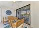 Enclosed lanai with seating area and view of outdoors at 410 Mission E Trl # H, Venice, FL 34285