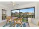 Enclosed lanai with furniture set overlooking tranquil water view at 410 Mission E Trl # H, Venice, FL 34285