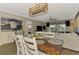 Living room featuring a view of the dining room, balcony, and television at 410 Mission E Trl # H, Venice, FL 34285