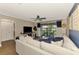 Comfortable living room with a ceiling fan, balcony access, and tasteful decor at 410 Mission E Trl # H, Venice, FL 34285