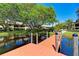 Scenic view of waterfront living, featuring a tranquil pond and mature trees at 410 Mission E Trl # H, Venice, FL 34285