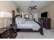 Comfortable main bedroom with dark wood furniture, ceiling fan, and decorative lighting at 2198 Chenille Ct, Venice, FL 34292