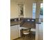 Kitchen island bar with stained glass window decoration and seating at 102 Calle Del Paradiso Est, Venice, FL 34285