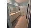 Bright bathroom boasting dual sinks, a large mirror, and a glass-enclosed shower at 102 Mestre Ct, North Venice, FL 34275