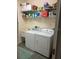 Efficient laundry room with a washing machine, dryer, and ample shelving for storage at 102 Mestre Ct, North Venice, FL 34275