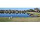 Scenic view of the pond, with houses reflected in the calm water at 102 Mestre Ct, North Venice, FL 34275