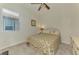 Cozy bedroom featuring neutral colors, a ceiling fan, and natural light at 11810 Tapestry Ln, Venice, FL 34293