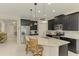 Modern kitchen features stainless appliances, granite counters, and pendant lighting at 11810 Tapestry Ln, Venice, FL 34293