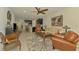 Cozy living room showcasing an open floor plan with adjacent kitchen and bar seating at 11810 Tapestry Ln, Venice, FL 34293