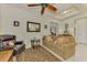 Open concept living room with ceiling fan and tile flooring leading to the dining area at 11810 Tapestry Ln, Venice, FL 34293