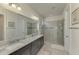 Bathroom features double sinks and a large shower with a glass door at 11810 Tapestry Ln, Venice, FL 34293