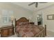 Main bedroom showcases wooden furniture, tray ceiling, and view into the bathroom at 11810 Tapestry Ln, Venice, FL 34293