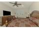 Main bedroom featuring an oversized dresser, wooden furniture, and a ceiling fan at 11810 Tapestry Ln, Venice, FL 34293