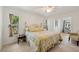 Bright bedroom featuring natural light, tile flooring, a ceiling fan and a comfortable bed with a plaid comforter at 1201 Ewing St, Nokomis, FL 34275