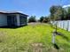 Expansive backyard featuring a screened-in lanai and well-maintained lawn at 12316 Durango Ave, North Port, FL 34287