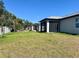 Lush green lawn and a home featuring a screened-in back porch offer comfortable outdoor living space at 12316 Durango Ave, North Port, FL 34287