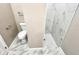 Half bathroom with toilet and a walk-in tiled shower with glass surround at 12316 Durango Ave, North Port, FL 34287
